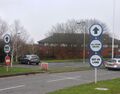 Moto circular signs saying "all other routes, get in lane".